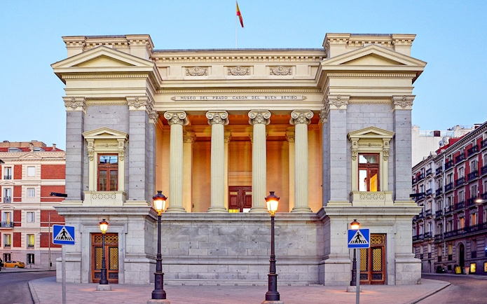 Prado Museum entrance with neoclassical columns in Madrid, Spain.
