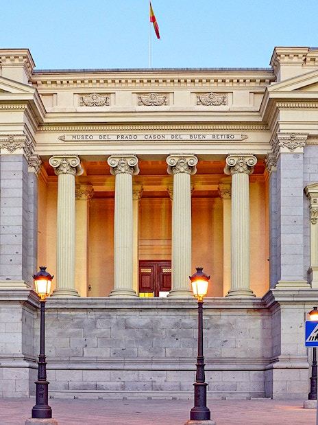 Prado Museum entrance with neoclassical columns in Madrid, Spain.