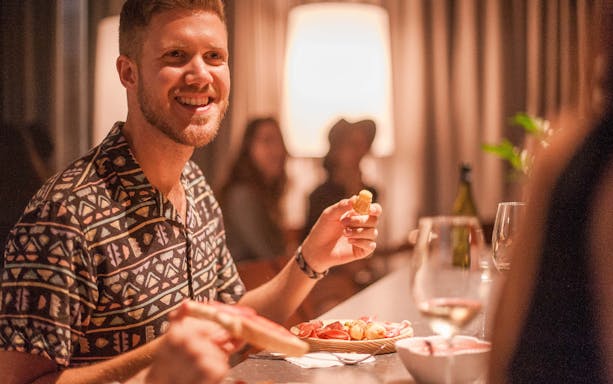 Man enjoying tapas and wine during Montserrat walking tour.
