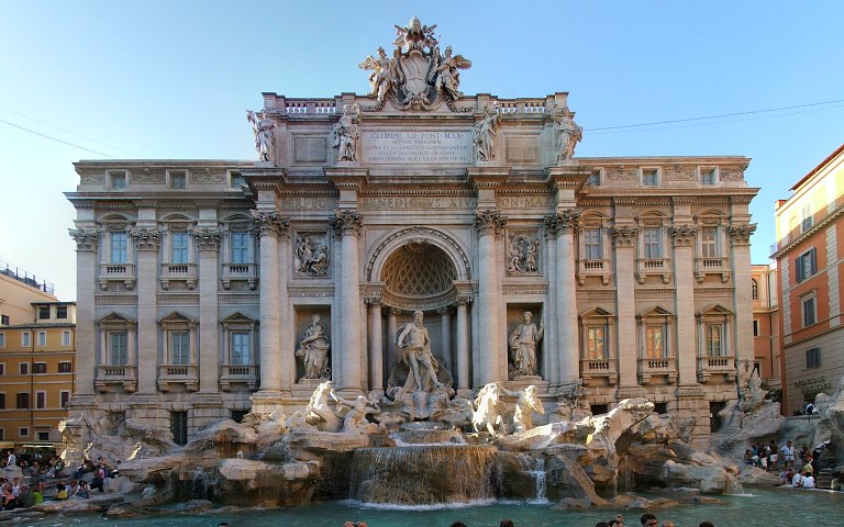 Trevi Fountain in Rome with baroque sculptures and flowing water.