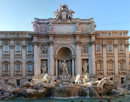 Trevi Fountain in Rome with baroque sculptures and flowing water.