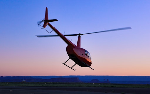 Helicopter taking off at sunset for a couple's private tour.