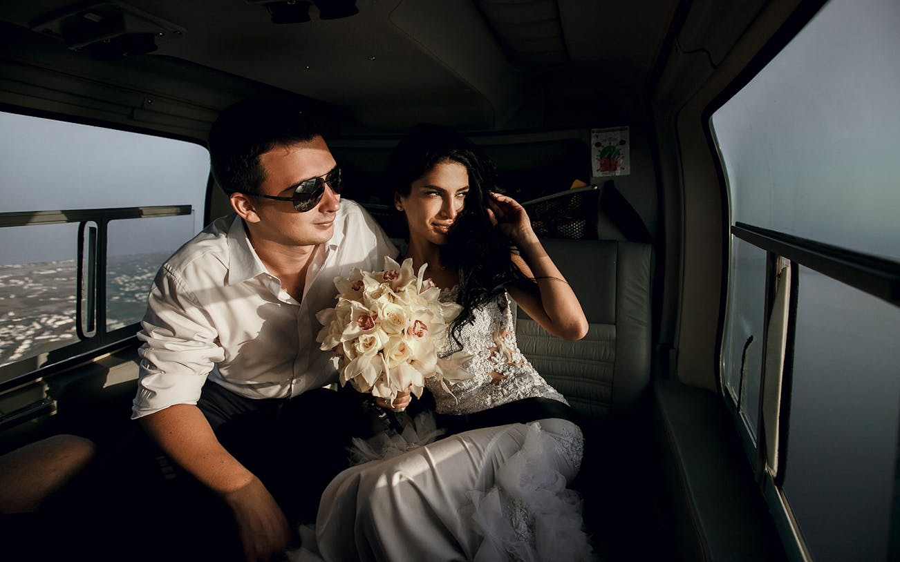 Couple enjoying a private helicopter tour with city views.