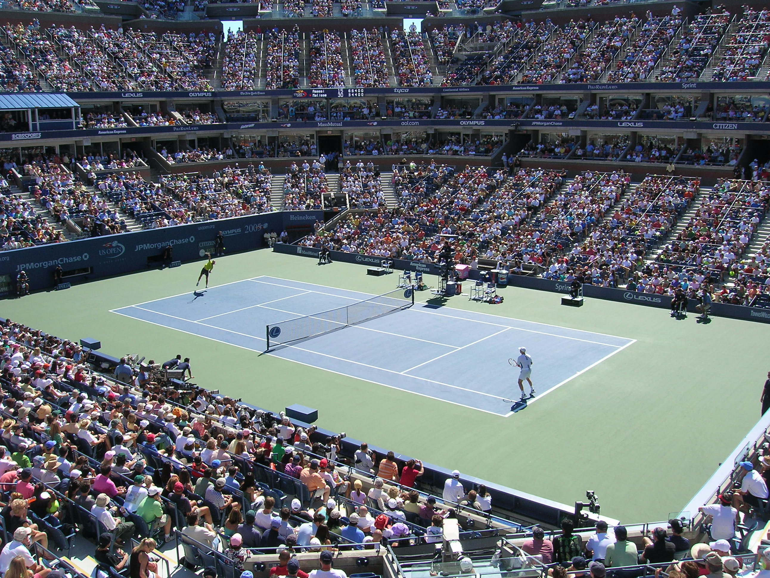 US Open Tennis Championship, Round 2 match in progress at a packed stadium.