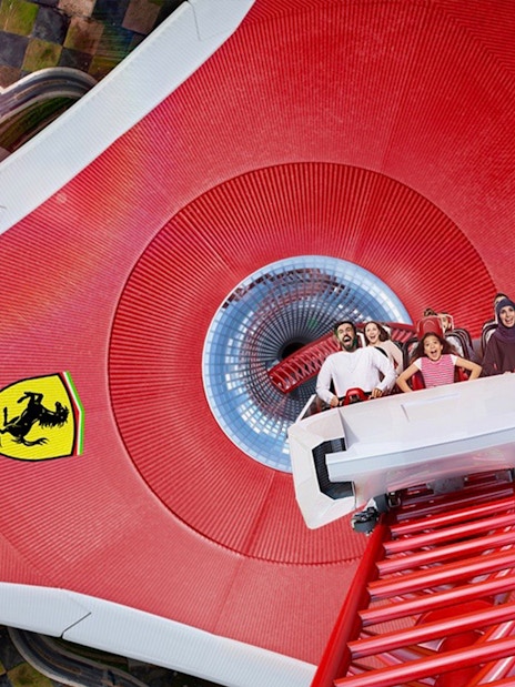 Roller coaster at Ferrari World Abu Dhabi with excited riders.