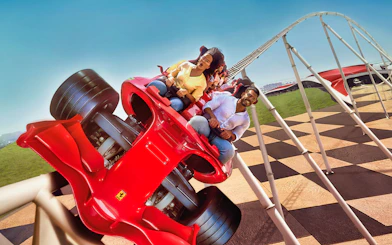 Roller coaster at Ferrari World Abu Dhabi with excited riders.