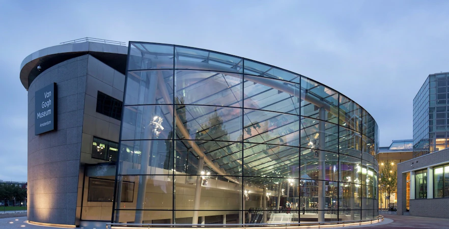 Van Gogh Museum entrance in Amsterdam, featuring modern glass architecture.