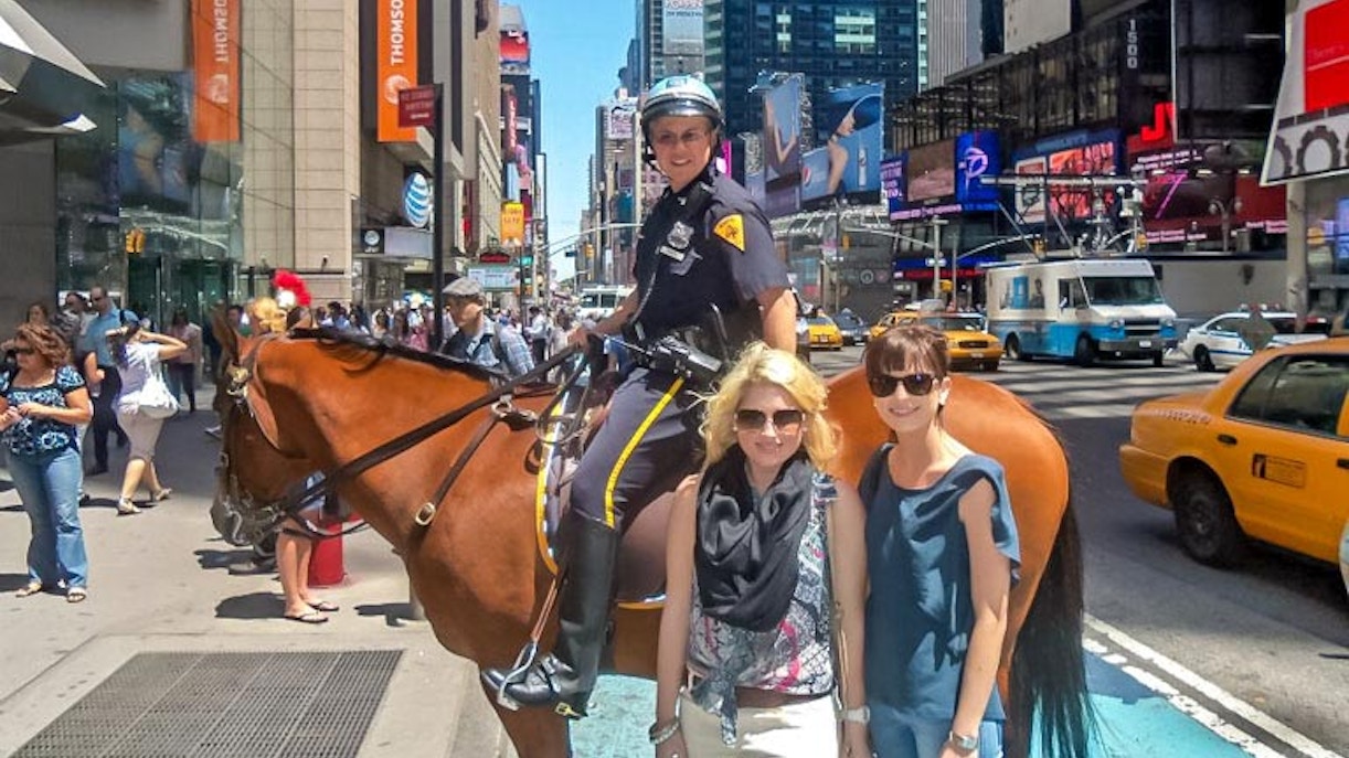 Mounted police officer in Times Square with tourists, part of Times Square & Greenwich Village Tour.