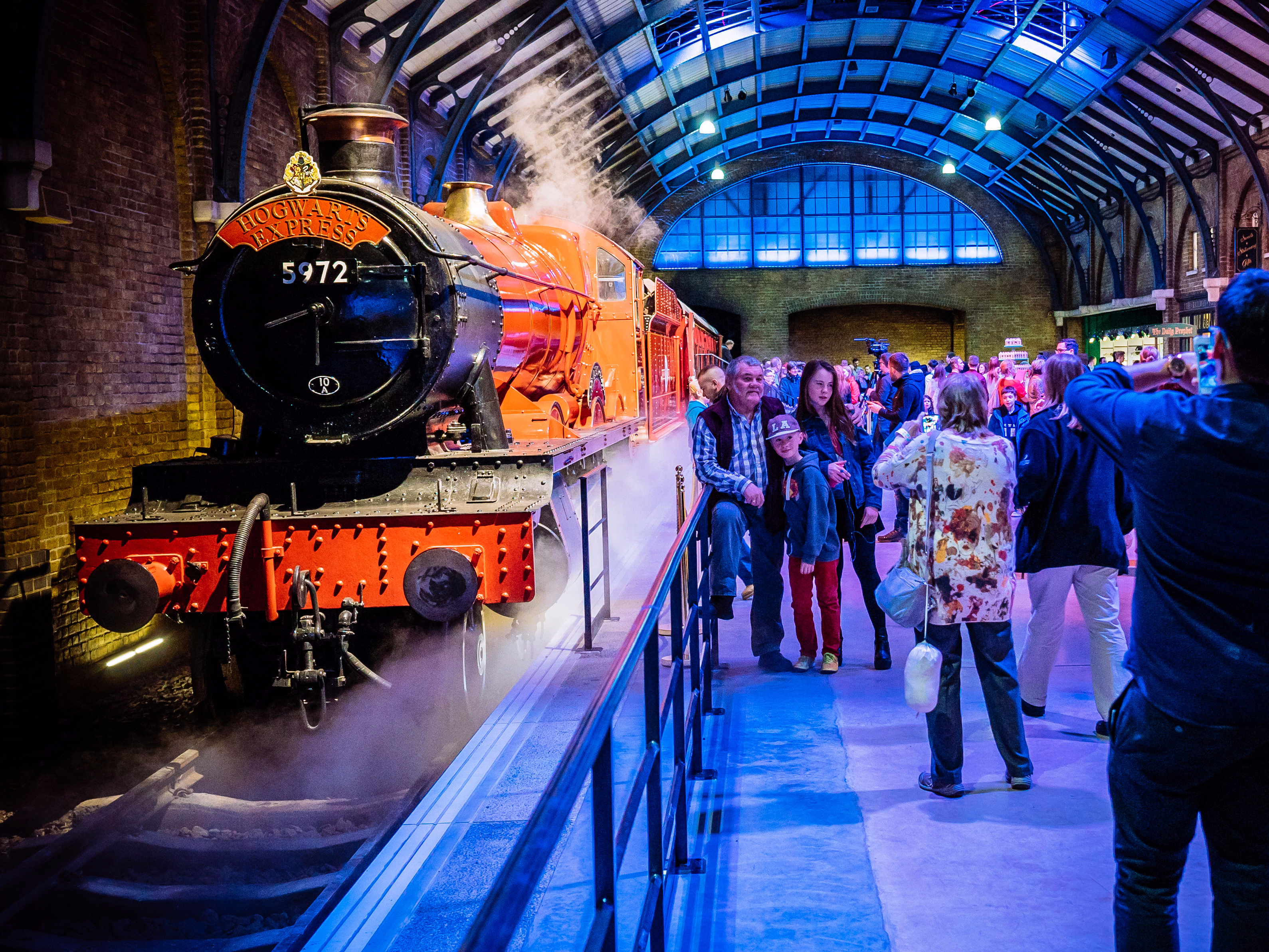 Hogwarts Express at Warner Bros. Studio Tour with visitors taking photos.