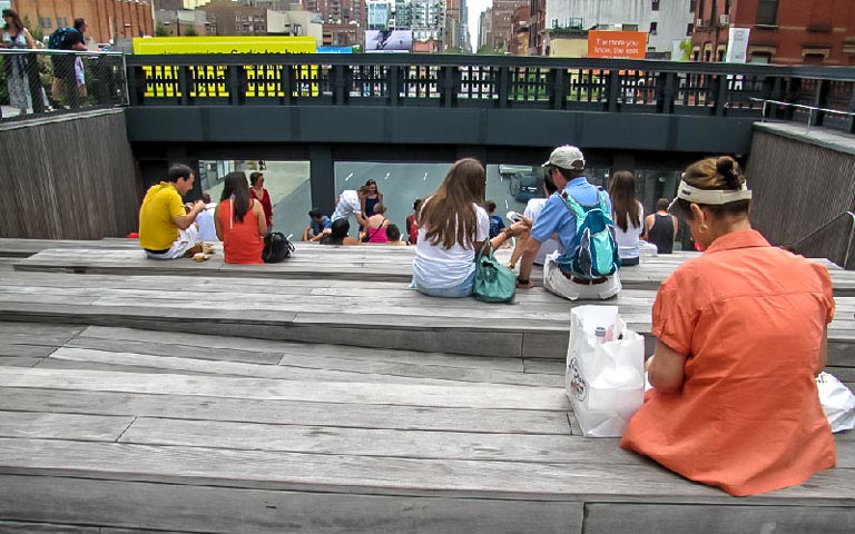 Visitors sitting on benches at the High Line park in New York City during the Highline & Greenwich Village Tour.