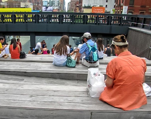 Visitors sitting on benches at the High Line park in New York City during the Highline & Greenwich Village Tour.
