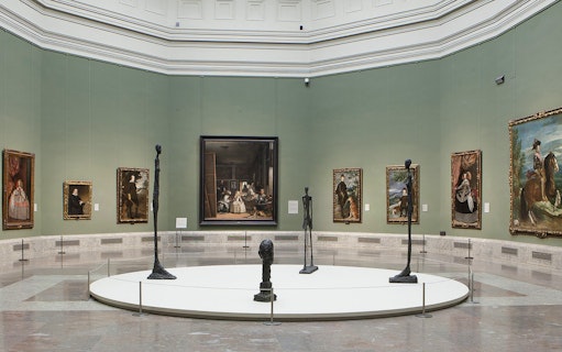 Visitors viewing classic art exhibits at Prado Museum, Madrid, Spain.