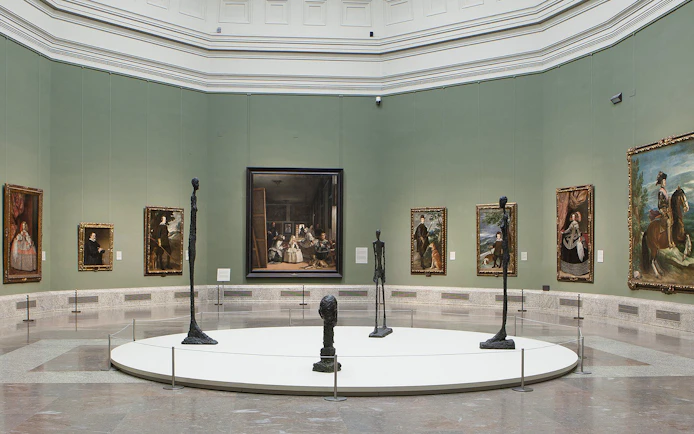 Visitors viewing classic art exhibits at Prado Museum, Madrid, Spain.