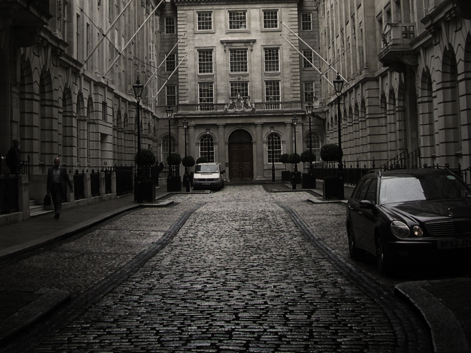 Cobblestone street in London with historic buildings, part of the Great Crime Tour.