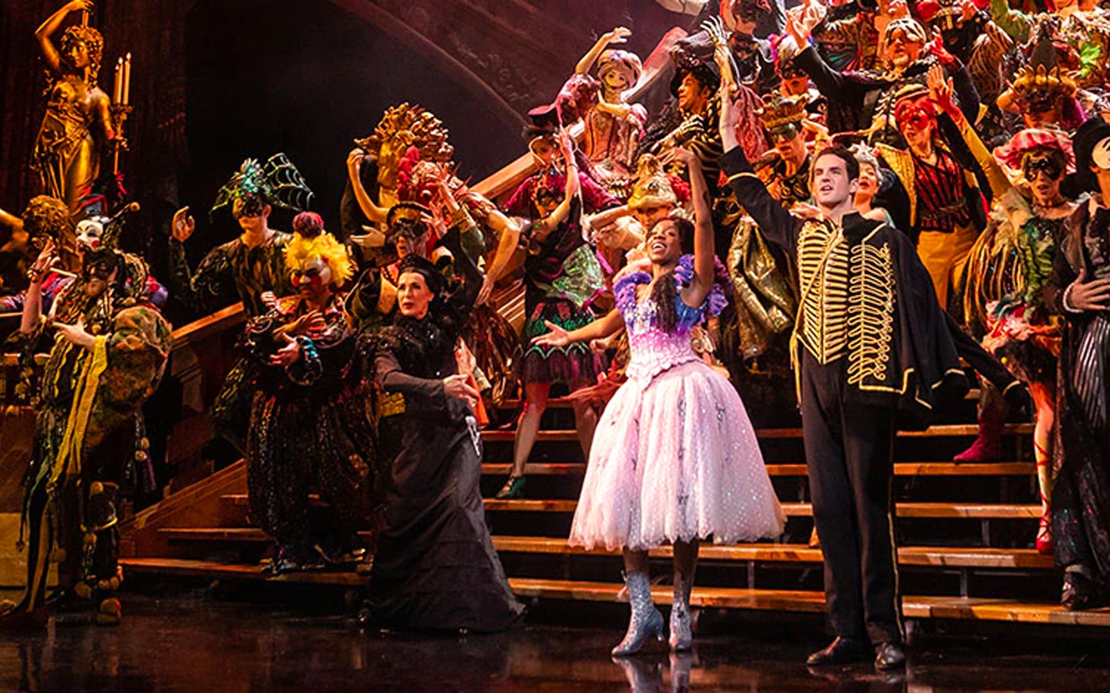 Performers in elaborate costumes on stage during Phantom of the Opera musical.