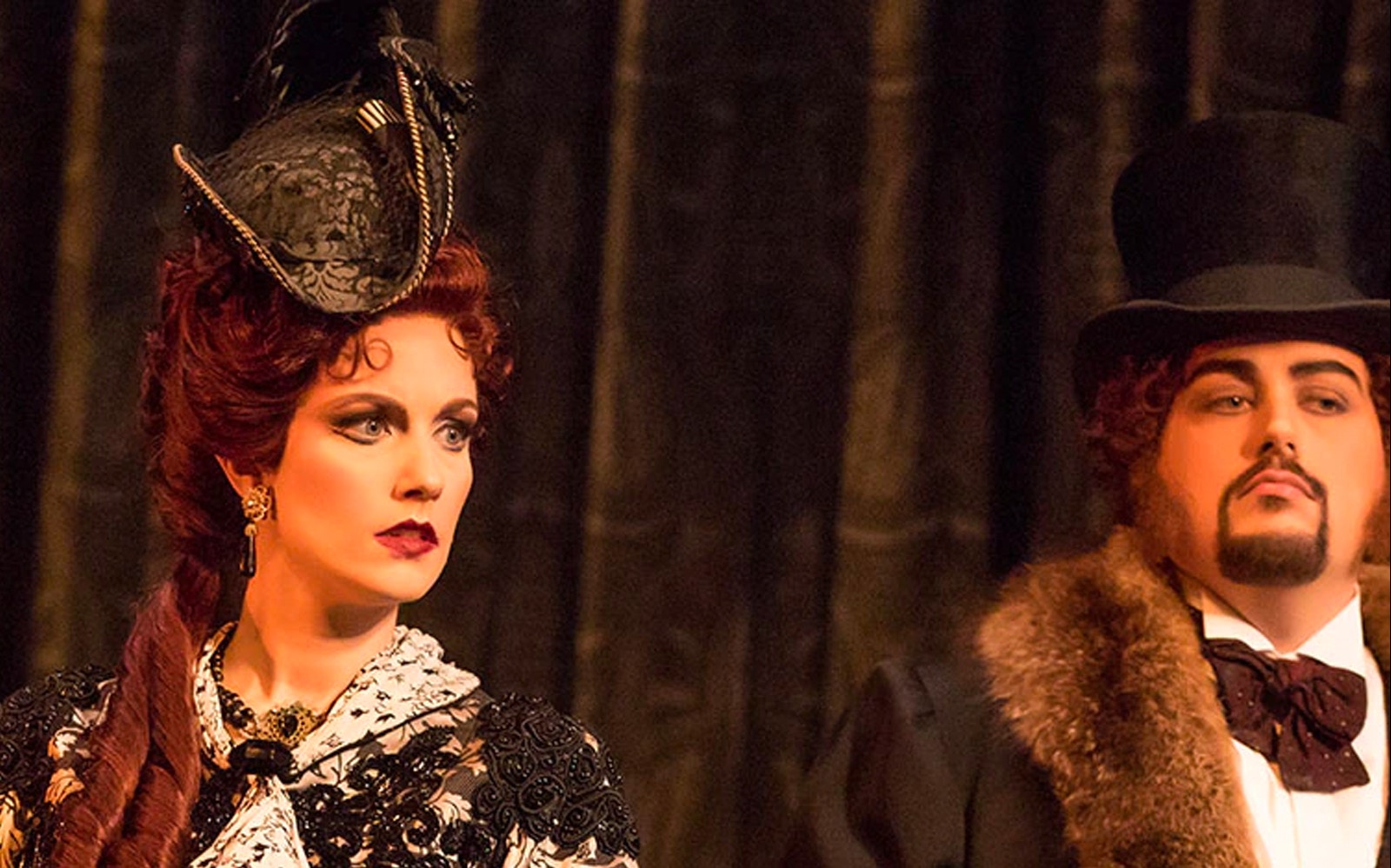 Actors in period costumes performing in Phantom of the Opera scene.