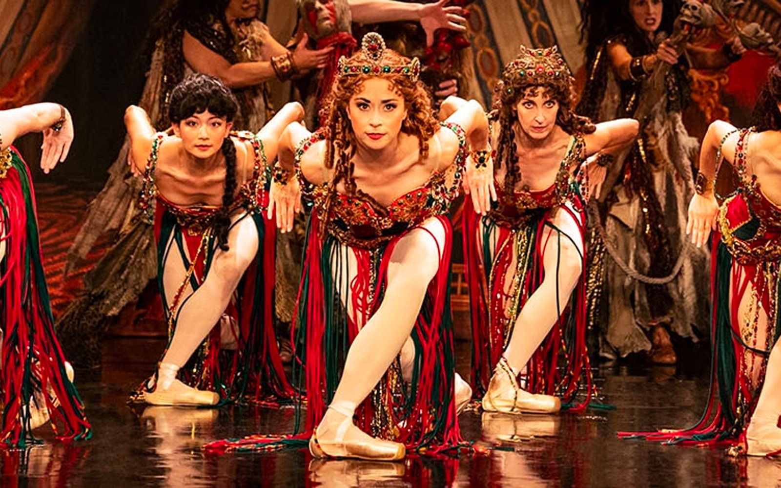 Performers in vibrant costumes during a Phantom of the Opera dance scene.