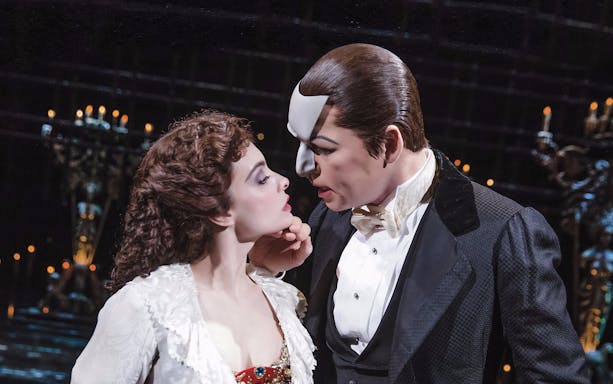 Actors performing a scene from Phantom of the Opera on stage.