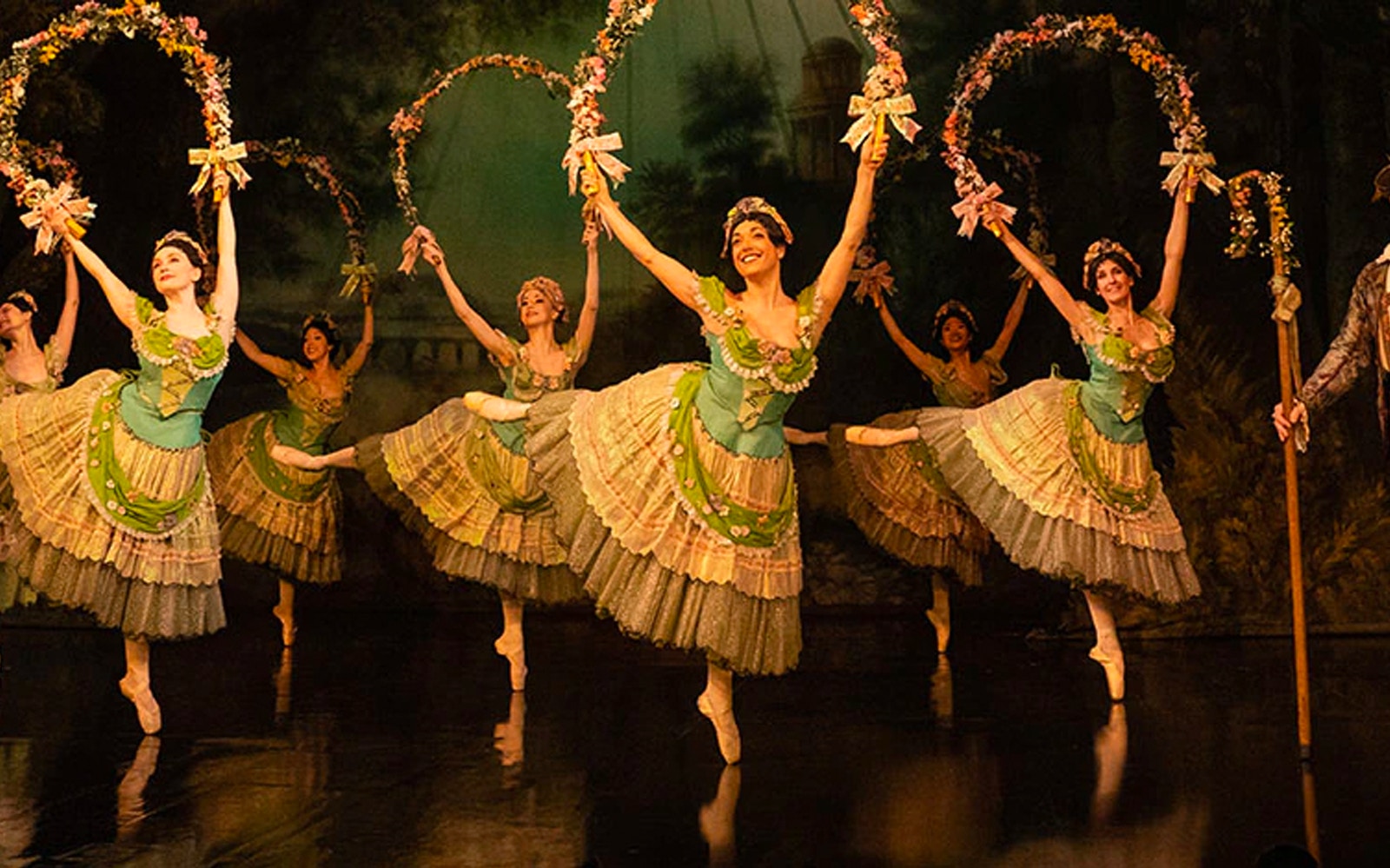 Ballet dancers performing in Phantom of the Opera scene with floral hoops.