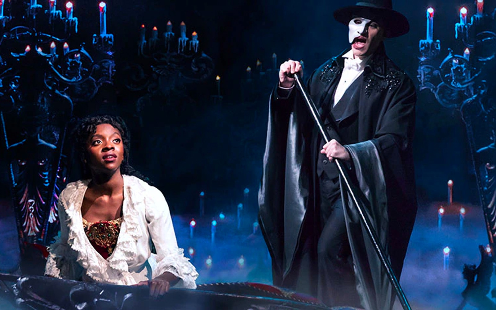 Phantom of the Opera scene with masked man and woman on stage