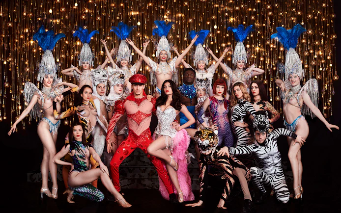 Performers in vibrant costumes at Paradis Latin cabaret show, Soirée Napoléon, Paris.