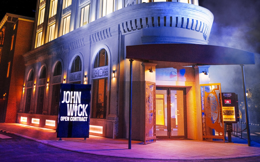 John Wick stunt show entrance at MOTIONGATE Dubai with dramatic lighting.