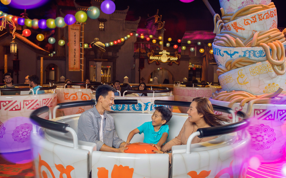 Family enjoying a ride at MOTIONGATE™ Dubai's Kung Fu Panda Land of Awesomeness.
