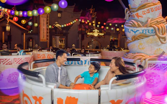 Family enjoying a ride at MOTIONGATE™ Dubai's Kung Fu Panda Land of Awesomeness.