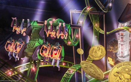 Roller coaster ride at MOTIONGATE™ Dubai with riders upside down on a green track.