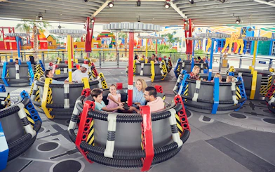 Families enjoying a spinning ride at LEGOLAND Dubai.