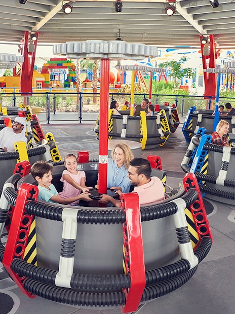 Families enjoying a spinning ride at LEGOLAND Dubai.