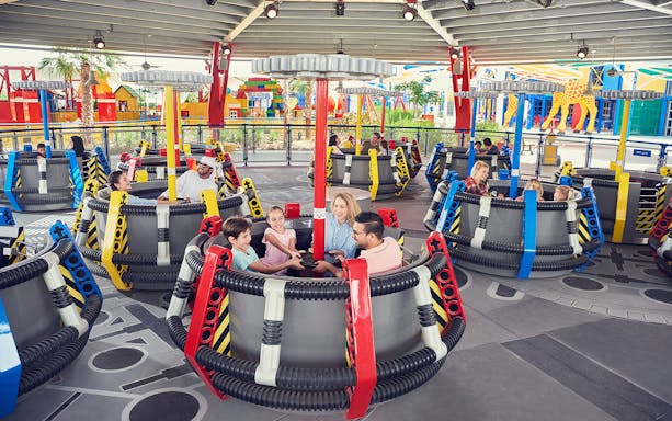 Families enjoying a spinning ride at LEGOLAND Dubai.