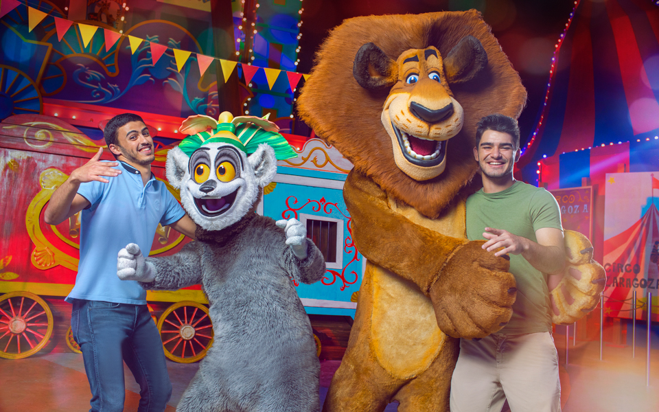 Guests posing with Madagascar characters at Dubai Parks and Resorts.
