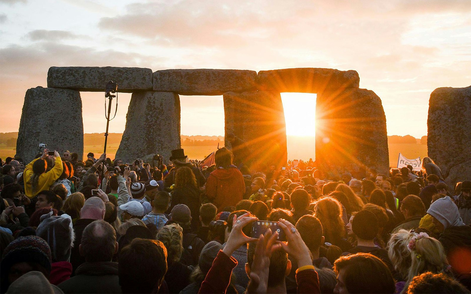 Crowd at Stonehenge during sunset on a day trip from London.