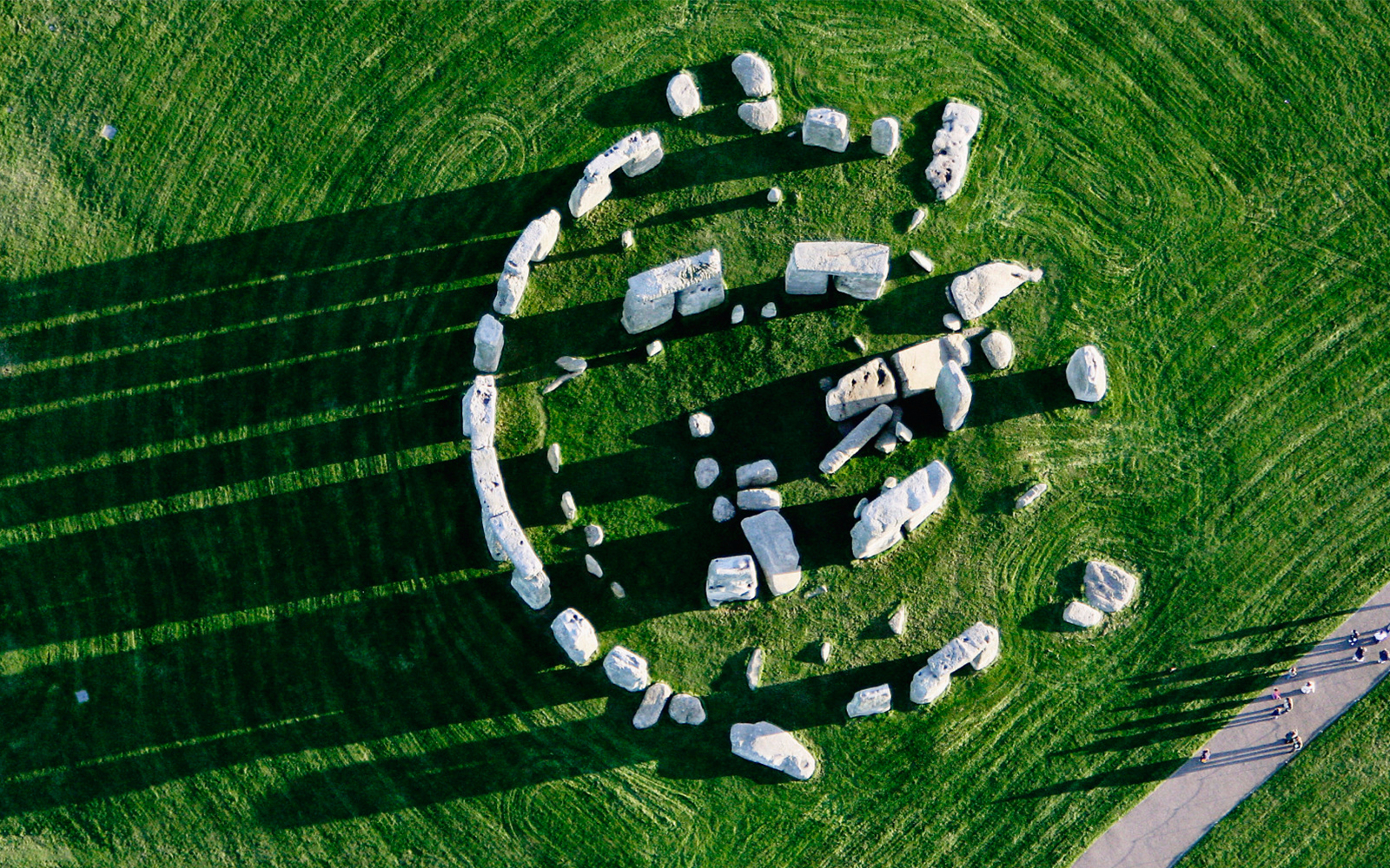 Stonehenge stones with tourists on a guided day trip from London to Bath.