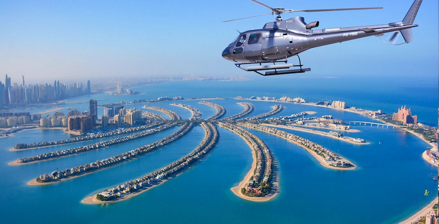 Helicopter flying over Palm Jumeirah, Dubai during Odyssey Helicopter Private Tour.