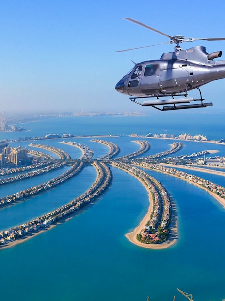 Helicopter flying over Palm Jumeirah, Dubai during Odyssey Helicopter Private Tour.