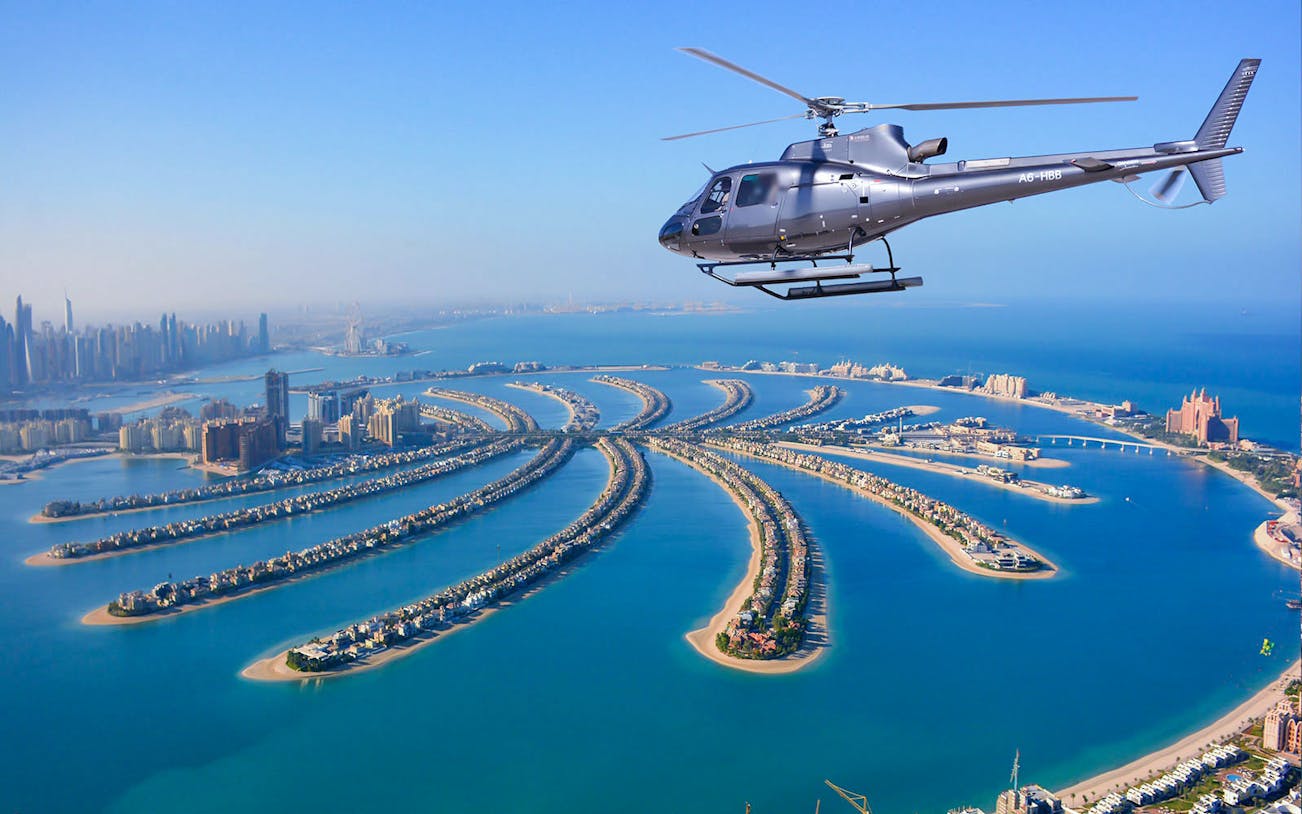 Helicopter flying over Palm Jumeirah, Dubai during Odyssey Helicopter Private Tour.