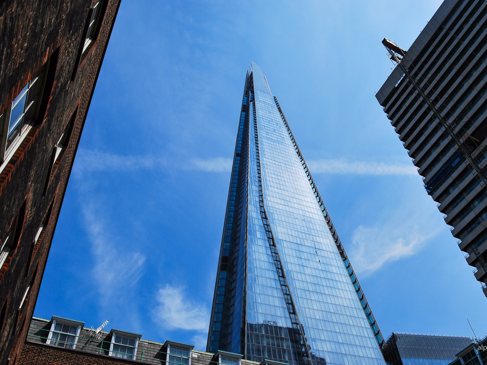 The Shard skyscraper in London against a clear blue sky.