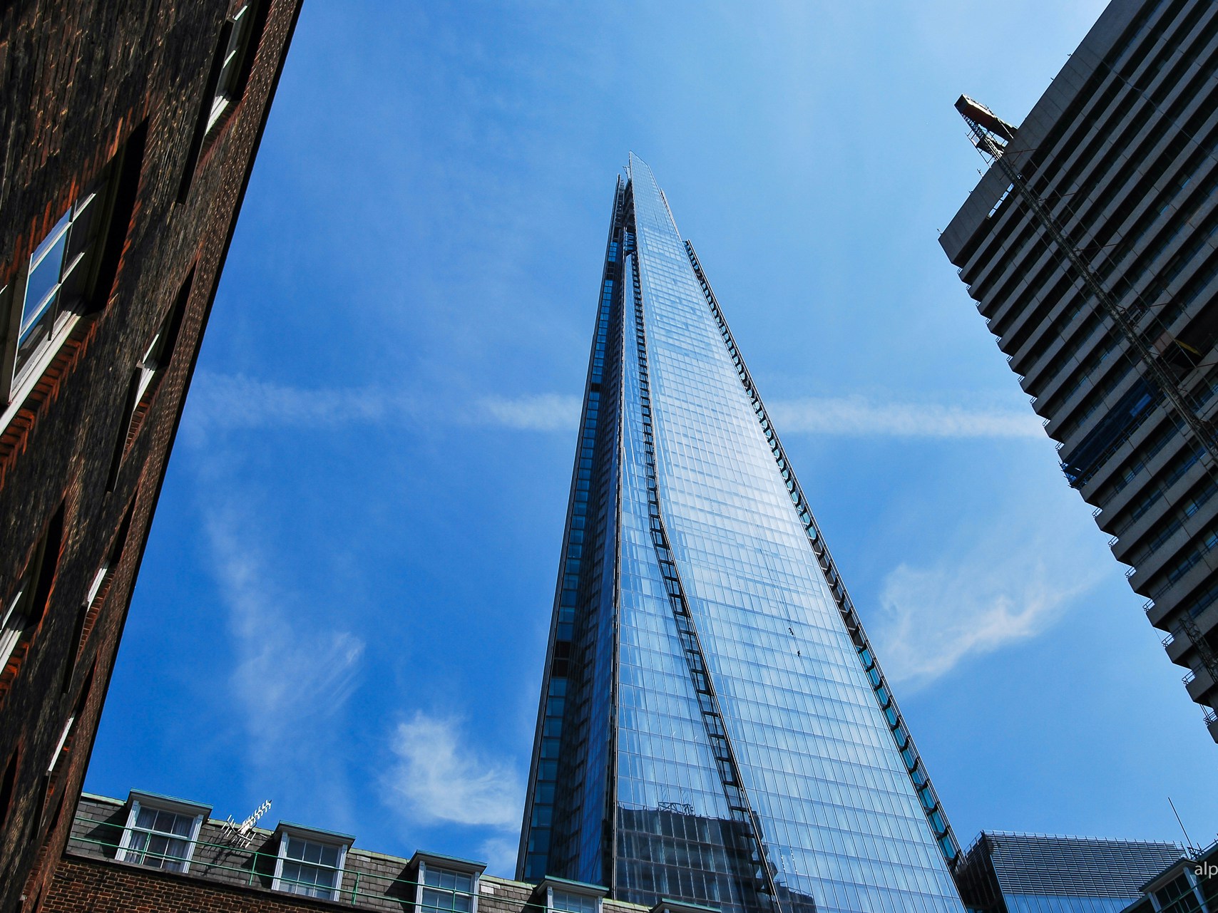 The Shard skyscraper in London against a clear blue sky.