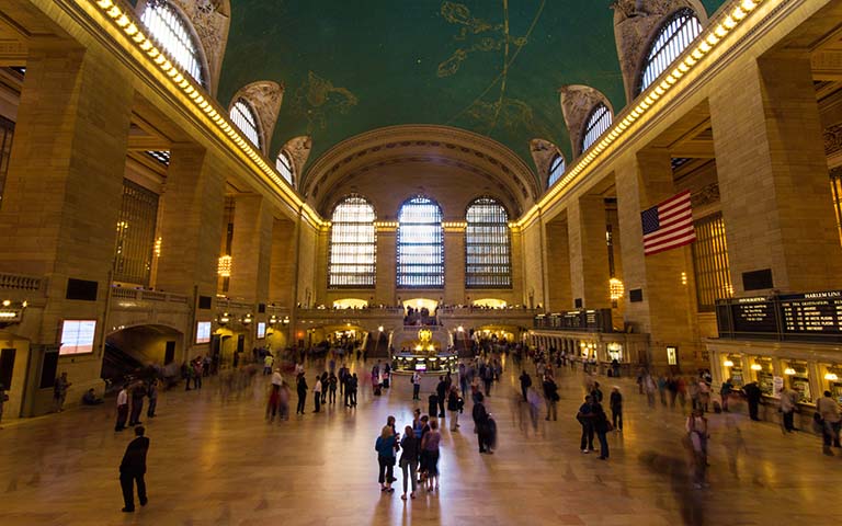 Grand Central Terminal interior with iconic clock and bustling crowd, New York City.