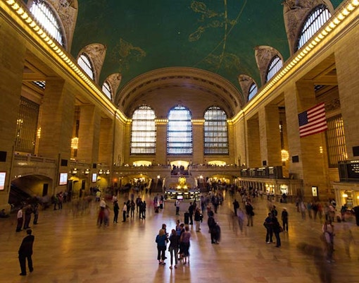 Grand Central Terminal interior with iconic clock and bustling crowd, New York City.