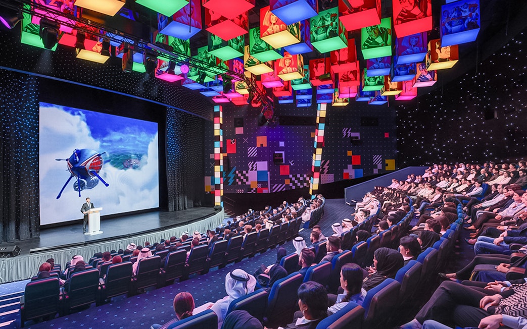 Audience watching a presentation at IMG Worlds of Adventure theater.