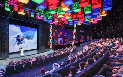 Audience watching a presentation at IMG Worlds of Adventure theater.