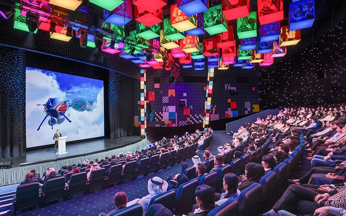 Audience watching a presentation at IMG Worlds of Adventure theater.
