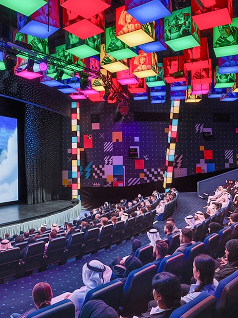 Audience watching a presentation at IMG Worlds of Adventure theater.
