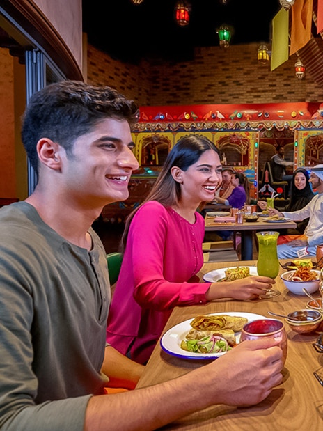 Group dining at IMG Worlds of Adventure restaurant, enjoying diverse cuisine.