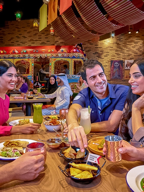 Group dining at IMG Worlds of Adventure restaurant, enjoying diverse cuisine.