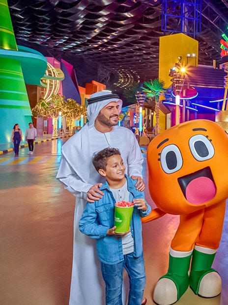Family taking a selfie with cartoon characters at IMG Worlds of Adventure, Dubai.