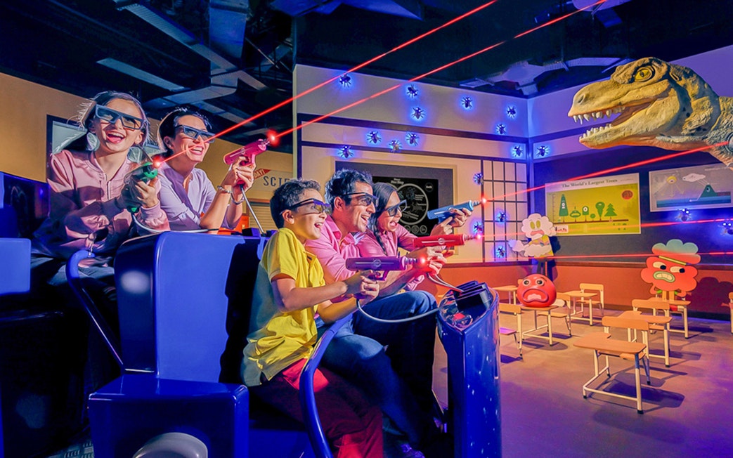 Visitors enjoying a 3D laser shooting game at IMG Worlds of Adventure.